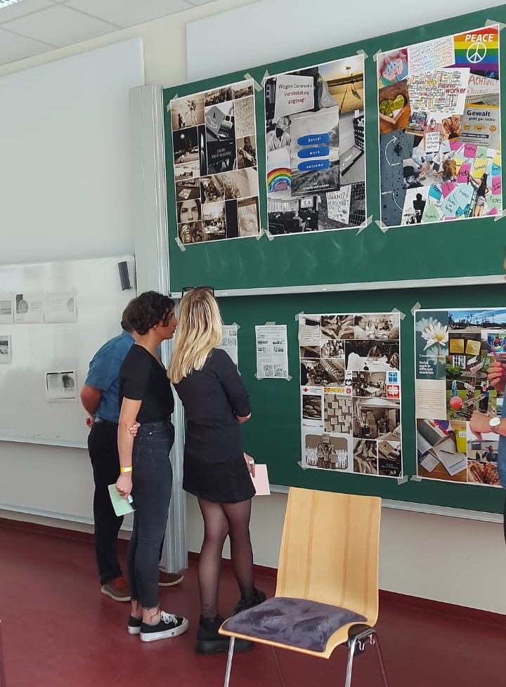 the workshop participants looking at information materials displayed on a board