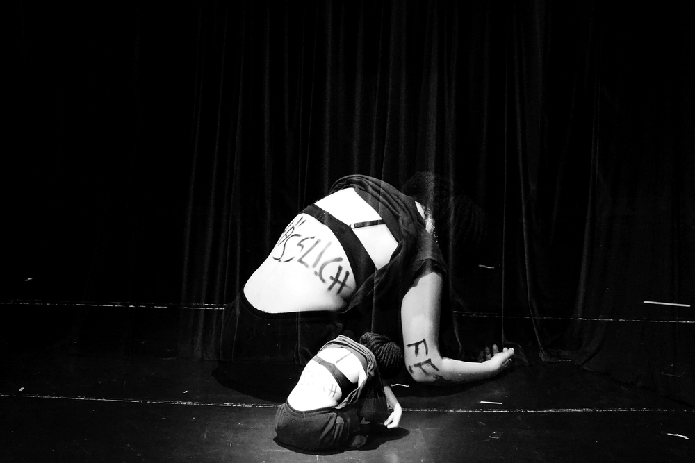 A still from a theatrical play, a black and white high-contrast photograph showing a fragment of a woman's body in underwear A still from a theatrical play, a black and white high-contrast photograph showing a fragment of a woman's body in underwear