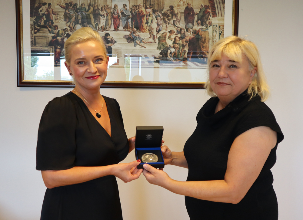 Two women with the medal