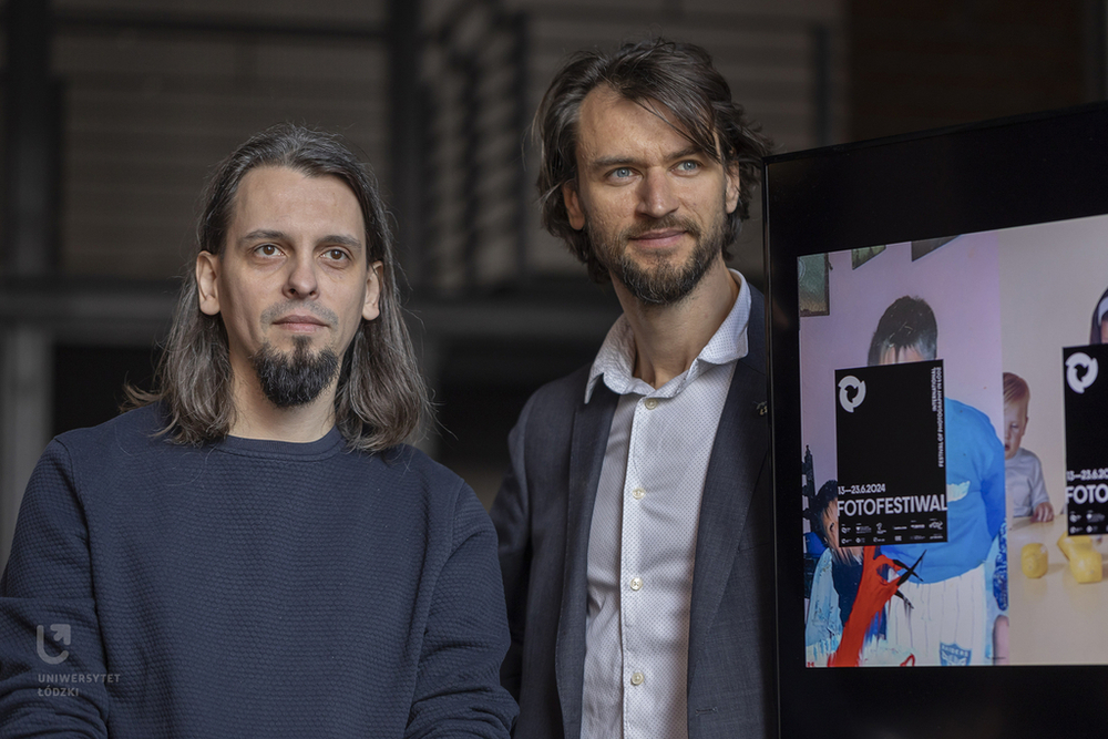 Bartłomiej Talaga and Karol Jóźwiak, two brunette men standing by the screen