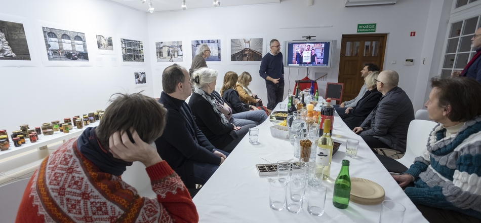 A group of people at a table in the gallery