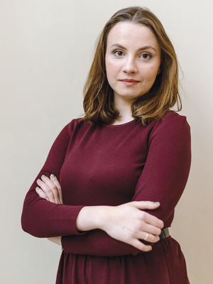 a portrait photo of Julia Anuszewska in a dark red dress