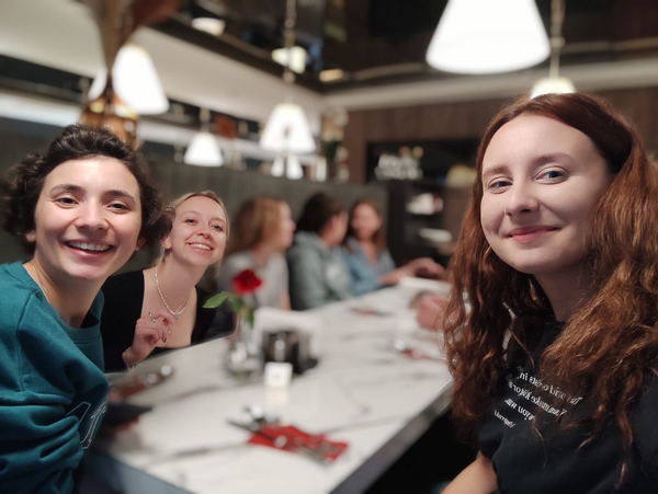 the workshop participants sitting together at a table and smiling