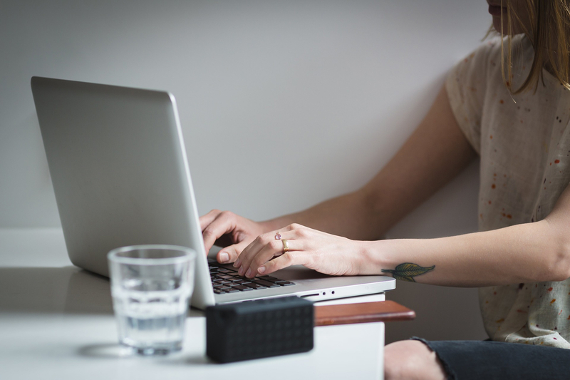 A girl typing on a laptop keyboard