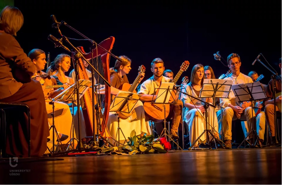 Members of the Academic Slavic Nations Music Band "Balalaikas" sitting on the stage with their instruments